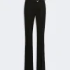 Black tailored trousers with a matching belt and gold buckle, full-length view
