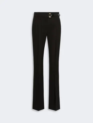 Black tailored trousers with a matching belt and gold buckle, full-length view