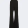 Black high-waisted, wide-leg trousers with a slim belt at the waist.