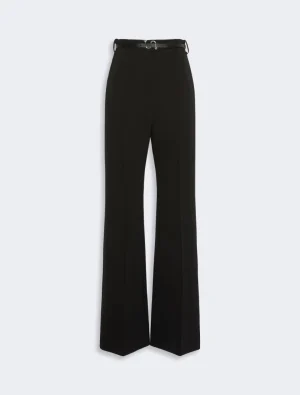 Black high-waisted, wide-leg trousers with a slim belt at the waist.