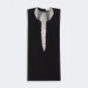 Black sleeveless shift dress with an elaborate silver bead collar and pearl-fringe pendant down the front.