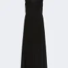 Long black sleeveless maxi dress with a V-neck and clean front seam, floor-length.