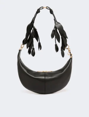 Black crescent-shaped leather handbag with gold hardware and decorative leaf-strap handles