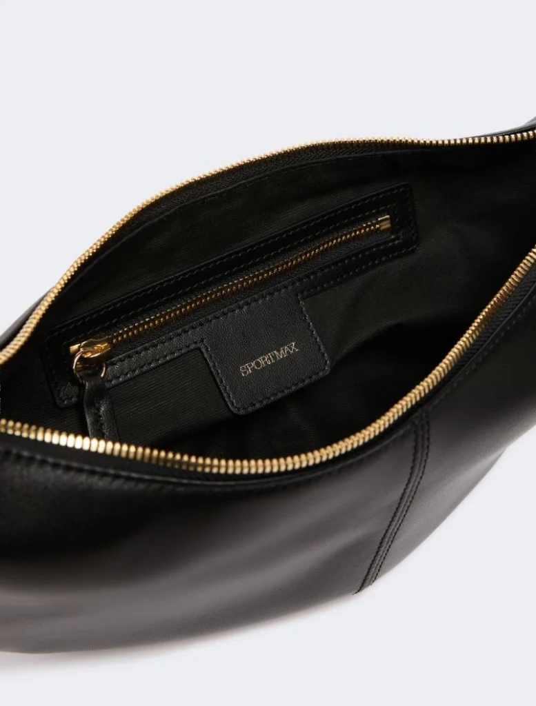 Inside a black leather bag with a gold zip; small zip pocket and SPORTMAX tag on the pocket lining.