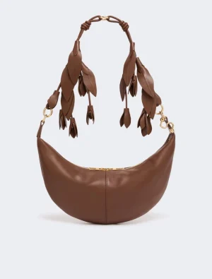 Brown crescent-shaped leather handbag with a knotted fringe strap and gold hardware.