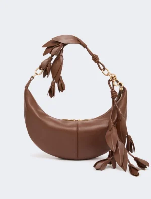 Brown crescent-shaped leather handbag with gold hardware and leafy fringe tassels.