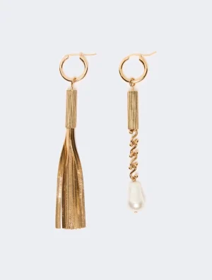 Gold-tone tassel earrings with a long fringe on the left and a pearl drop with chain on the right