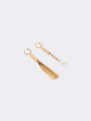 Gold-tone hoop earrings with a tassel on one and a pearl drop on the other on a white background
