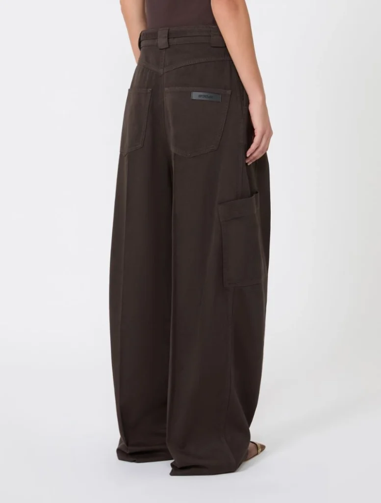 Back view of dark brown wide-leg cargo pants with large rear pockets and a side cargo pocket, worn by a model.