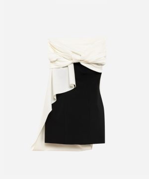 Black fitted strapless dress with a white draped top tied in a knot at the waist and cascading fabric