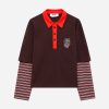 IMG_3195 - New Trend Brown polo shirt with red collar and button placket, layered over striped long sleeves.