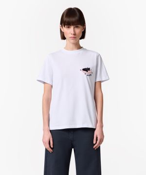 Model wearing a white T-shirt with a small embroidered patch on the left chest, paired with dark navy pants.