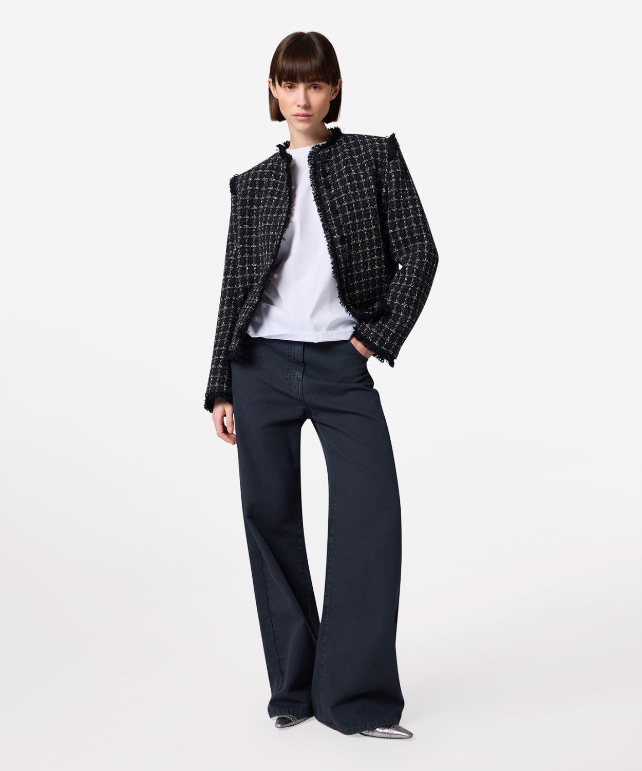 IMG_3203 - New Trend Fashion model wearing a black-and-white textured tweed jacket, white top, and navy wide-leg pants, posing confidently.