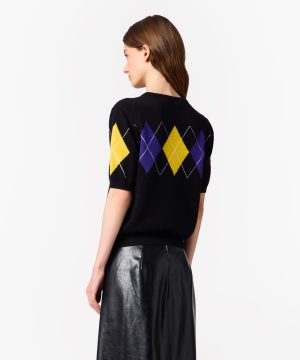 Back view of a black knit sweater with a yellow and purple argyle diamond pattern, worn by a model