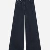 Dark indigo wide-leg jeans with a button and zip fly, front pockets, and contrast stitching. Behind-the-heel length shows their wide silhouette.