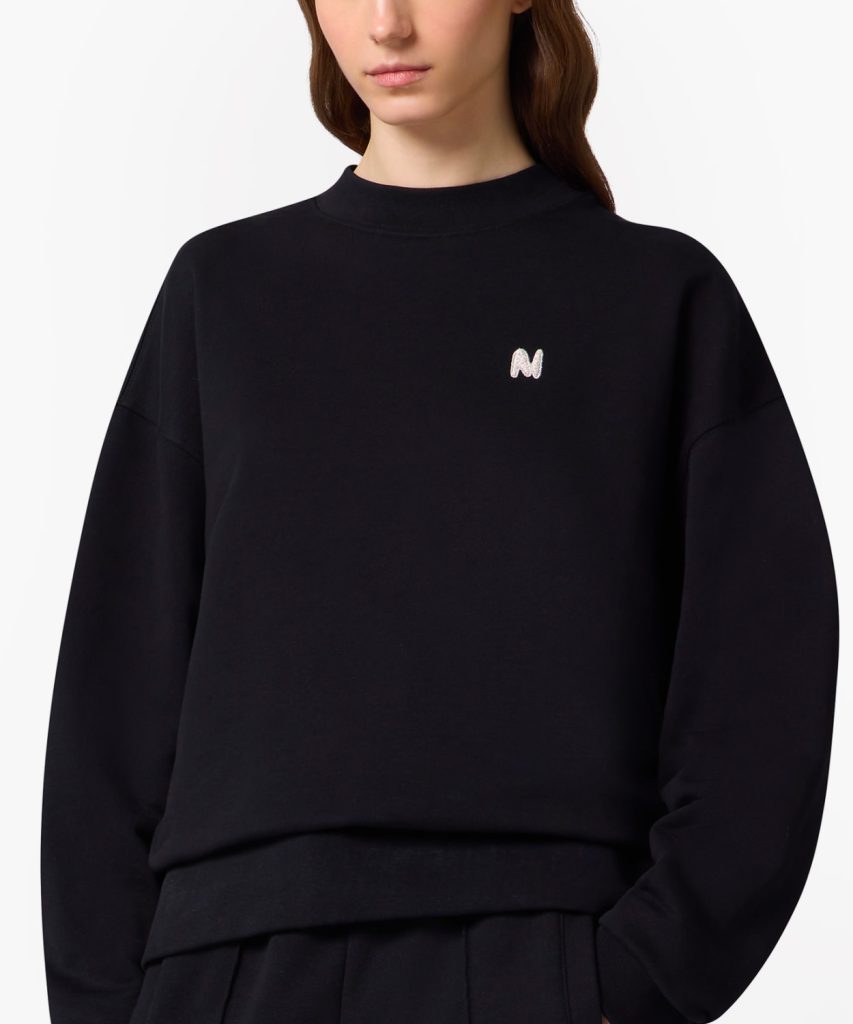 Black sweatshirt with a small white embroidered 'N' logo on the left chest area.