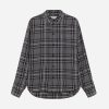 Grey and black plaid button-down flannel shirt with a curved hem and collar on a neutral background.