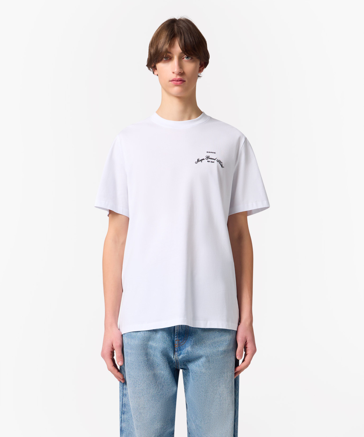 IMG_3251 - New Trend White short-sleeve T-shirt with small chest logo, modeled with light-wash jeans against a plain background