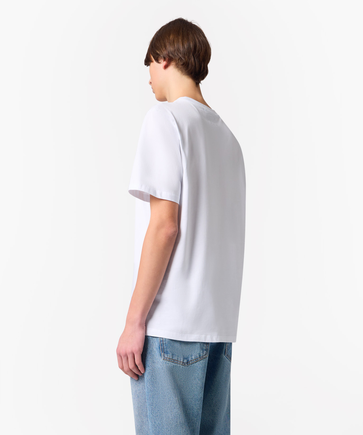 IMG_3252 - New Trend Back view of a person wearing a plain white T-shirt and blue jeans against a white background in a studio setting, neutral pose.