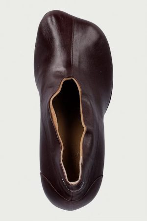 Top-down view of a dark brown leather slip-on shoe with a large oval upper opening.