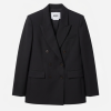 Black double-breasted blazer with peak lapels and four buttons, front flap pockets visible