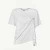 White oversized white T-shirt with a draped front and a small chest label detail on the right side of the chest area