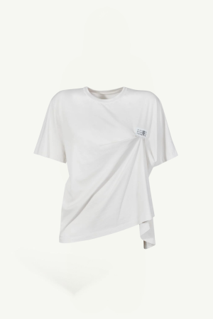 White oversized white T-shirt with a draped front and a small chest label detail on the right side of the chest area