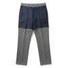 Layered fashion: navy shorts worn over grey checkered trousers with a matching checkered waistband detailing