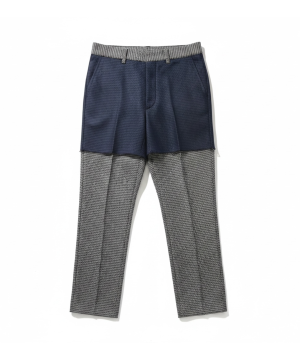 Layered fashion: navy shorts worn over grey checkered trousers with a matching checkered waistband detailing