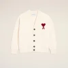 IMG_3432 - New Trend Cream cardigan with a red heart appliqué on the left chest, button-front and ribbed cuffs against a pale beige background.