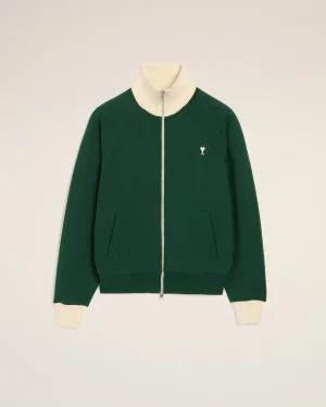 Green zip-up jacket with cream ribbed collar and cuffs, small white heart logo on chest.