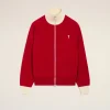 IMG_3448 - New Trend Red zip-front jacket with a cream ribbed collar and cuffs, featuring a small white heart emblem on the left chest.