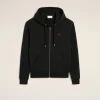 Black zip-up hoodie with a small red heart logo on the left chest, displayed against a light background.
