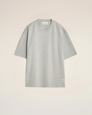 Flat lay of a light gray oversized T-shirt on a beige background, front view with short sleeves.
