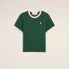 Green crew-neck t-shirt with cream collar and sleeve cuffs, small white heart with an X embroidery on the left chest.