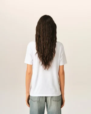 Back view of a person with long wavy brown hair wearing a white T-shirt, facing away from the camera.