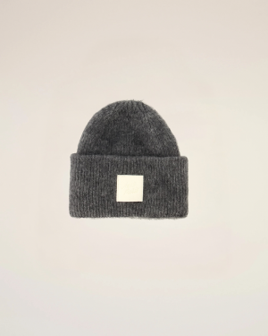 Dark gray knit beanie with a folded cuff and a small white square logo patch on the front.