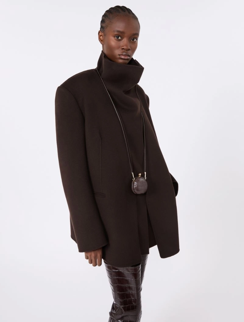IMG_3716 - New Trend Model in an oversized dark brown coat with a tall stand-up collar and a small round crossbody bag on a string.