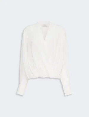 White draped blouse with long sleeves and elasticated hem, front twist detail. perfect for dressy casual wear.