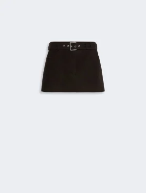 Black mini skirt with a matching belt and silver buckle on a light gray background.