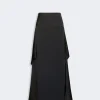 Long black floor-length skirt with draped side panels and an asymmetric overlay in satin-like fabric.