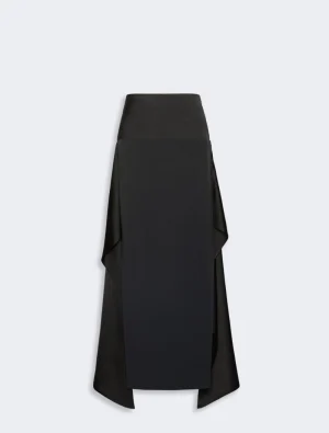 Long black floor-length skirt with draped side panels and an asymmetric overlay in satin-like fabric.