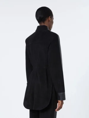 Back view of a person wearing a long black belted coat with a curved hem, seen from behind.
