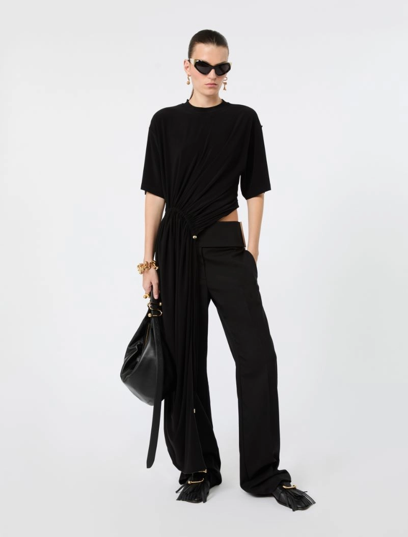 IMG_3779 - New Trend Model in an all-black ensemble: twisted draped top with a long sash, wide-leg pants, black handbag, and gold jewelry with sunglasses.
