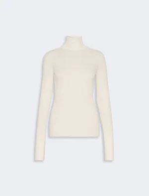 Cream ribbed turtleneck sweater with long sleeves on a light background.