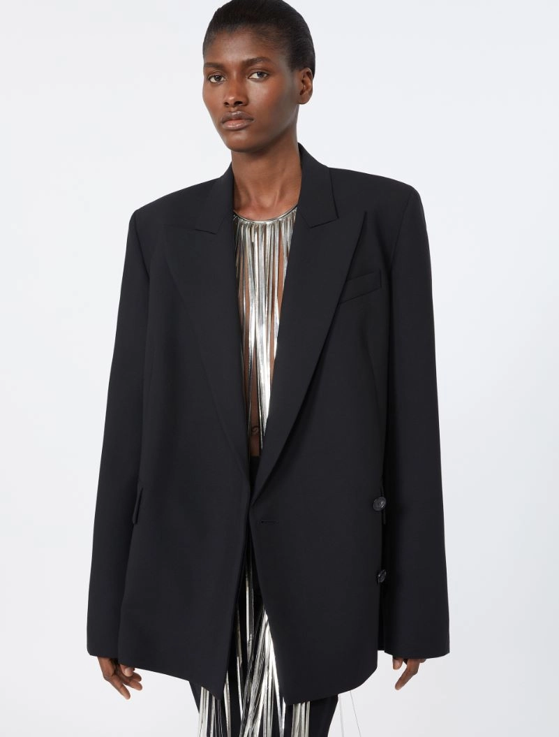 IMG_3799 - New Trend Model wearing an oversized black blazer over a metallic fringe dress, standing against a light background.
