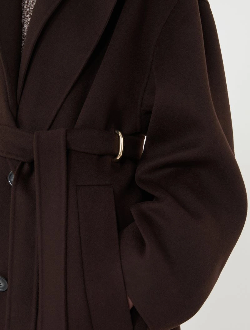 IMG_3823 - New Trend Close-up of a dark brown belted coat with a gold buckle and side pocket detail.