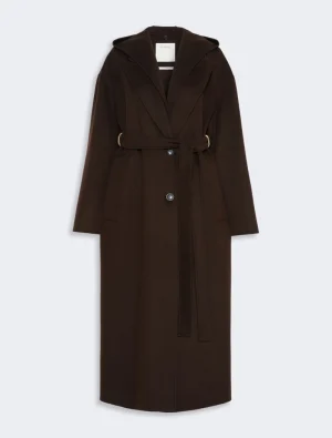 Long brown knee-length belted coat with wide lapels and front buttons on a pale background, showing a self-tie belt at the waist.