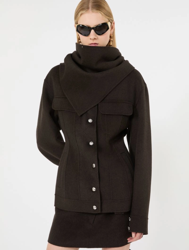 IMG_3834 - New Trend Model wearing a black wool coat with a large wrap-around scarf, sunglasses, and a short black skirt for a fashion shoot