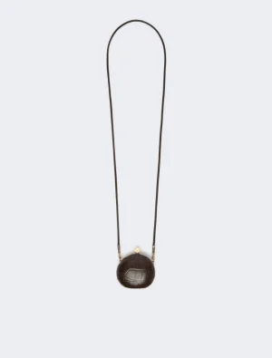Brown round textured crossbody bag with a long thin strap and gold hardware.